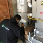 Worker Repairing Water Heater