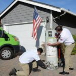 Team of Plumbers repairing water heater