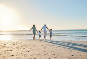 Family of four walking on beach