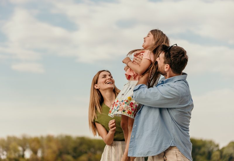 Parents holding daughter