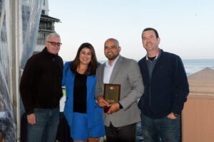Mike Counsil Plumbing and Rooter employees posing for a picture with an award
