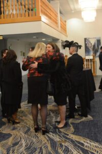 People interact in a lobby at the Mike Counsil Plumbing and Rooter event in San Jose, CA.