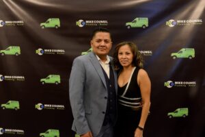 A man and woman pose together at the Mike Counsil Plumbing and Rooter event in San Jose, CA. 