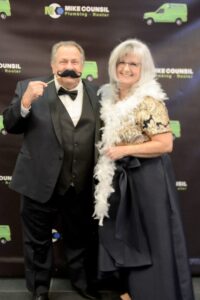 Gary and Susan from Mike Counsil Plumbing and Rooter celebrating together at a company event