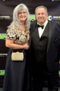 A couple smiles for a photo at the Mike Council Plumbing event in San Jose, CA
