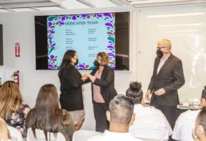 A woman shaking hands with another woman at a business event in San Jose, CA.