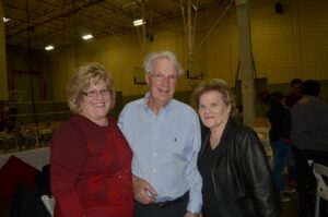 Three older adults pose together at the Mike Counsil Plumbing and Rooter event in San Jose, CA.