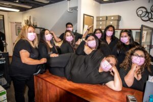 Mike Counsil Plumbing and Rooter employees posing for a picture wearing masks