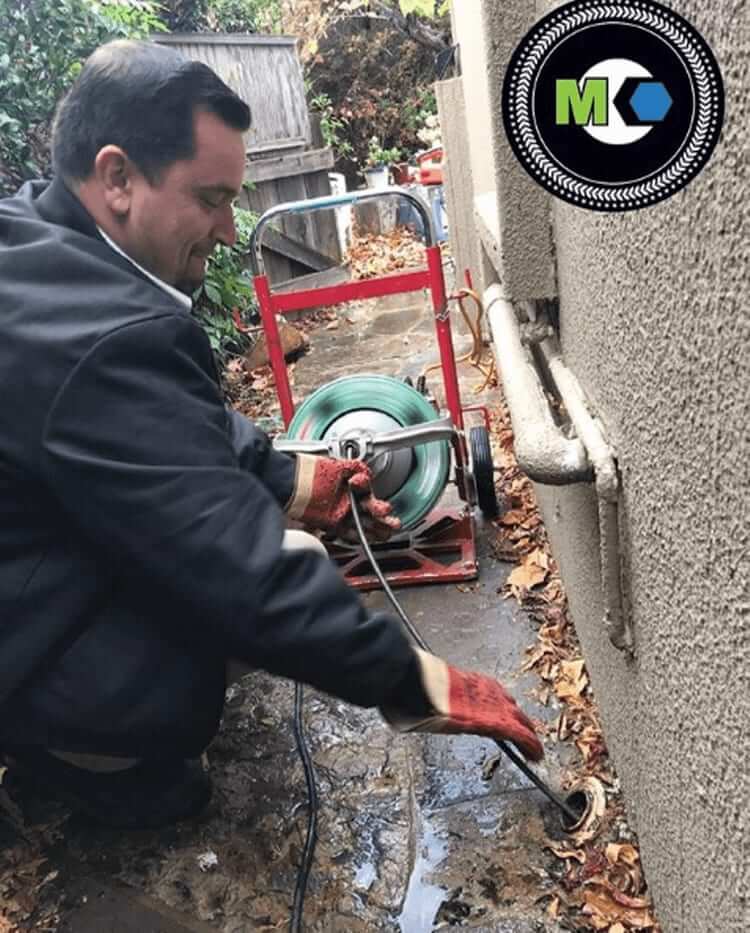 Mike Counsil Plumbing team member using hydro jetting equipment to clear a clogged drain