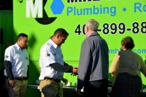 Men gather in front of a green truck, showcasing Tacos San Jose, located in San Jose, CA.