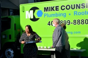 Mike Counsil Plumbing and Rooter employee accepting a gift