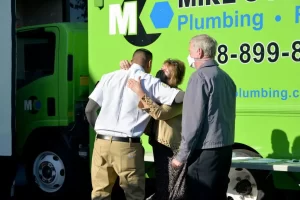 Jose and Brenda from Mike Counsil Plumbing and Rooter sharing a friendly hug