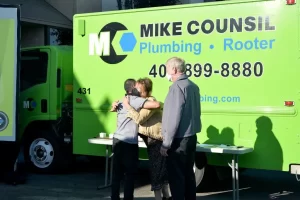 Brenda from Mike Counsil Plumbing and Rooter sharing a hug at a company event