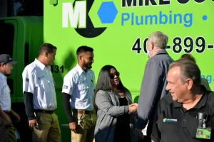 Erica and Mike shaking hands at the Mike Counsil Plumbing and Rooter event