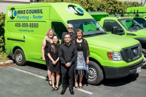 The accounting team in front of a Mike Counsil Plumbing and Rooter truck