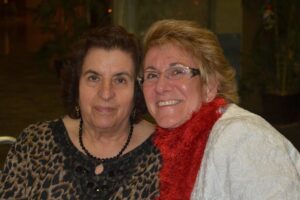 Two women smiling at the camera during the Mike Counsil Plumbing and Rooter event in San Jose, CA.